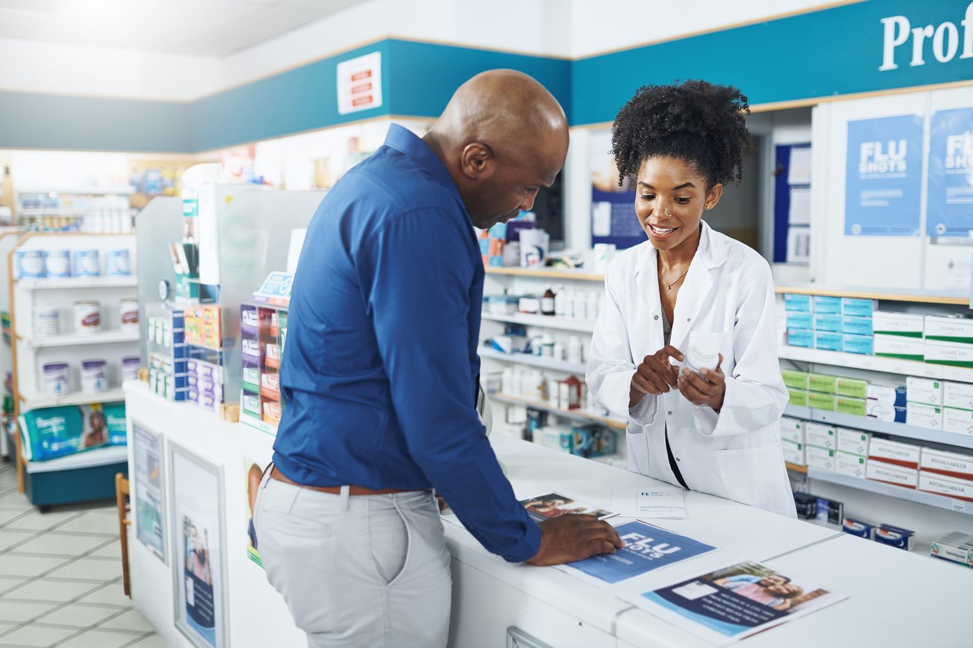Altruist pharmacist advising a customer on medicine at the counter